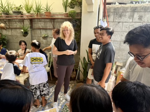 Outdoor crafts session with volunteers at the Oasis Family Center