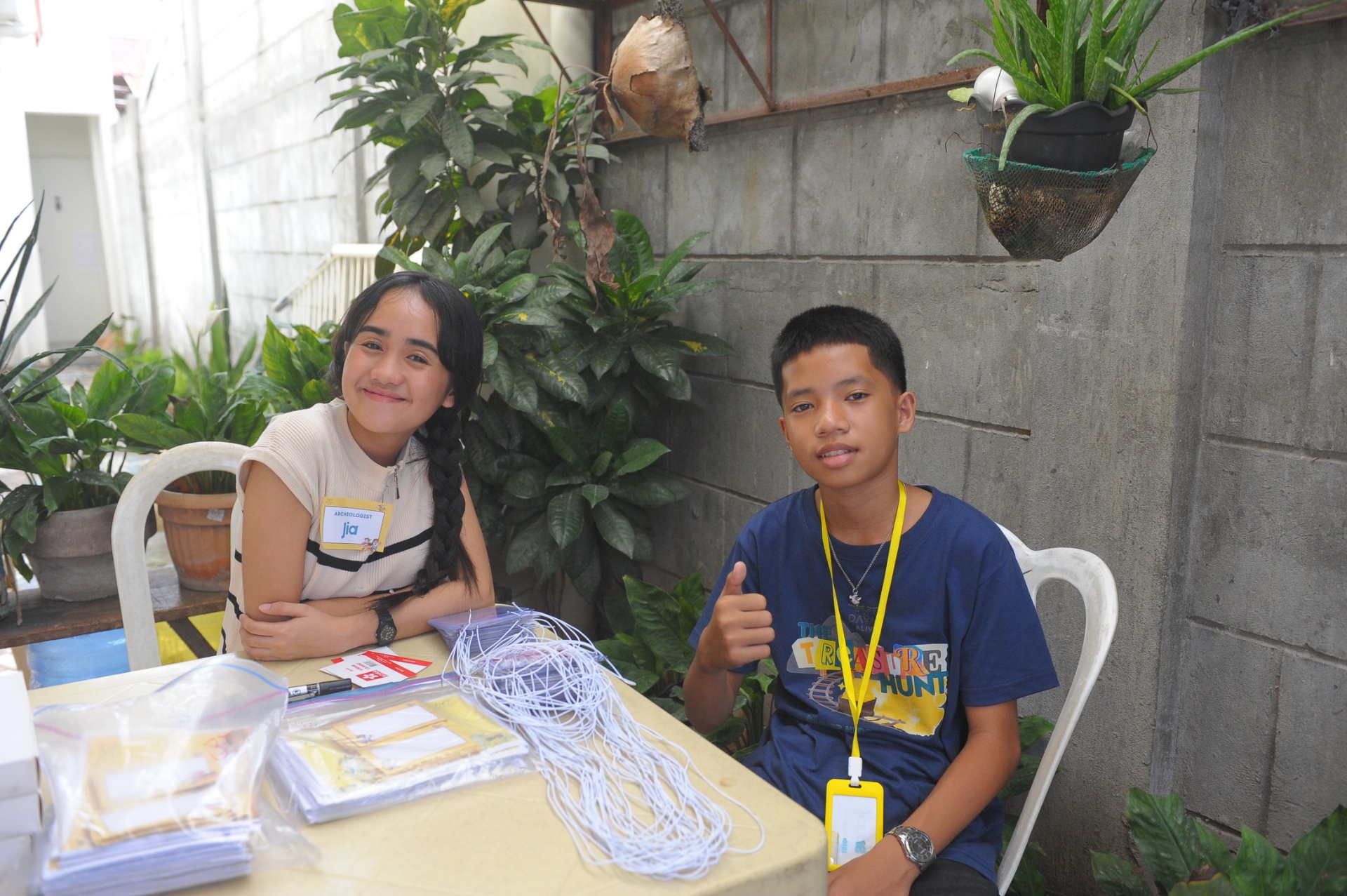 Two young volunteers preparing name tags and crafts